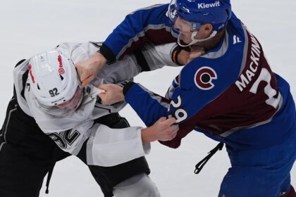 MacKinnon scores two goals and fights in Avalanche's 8-4 season-opening win over Kings