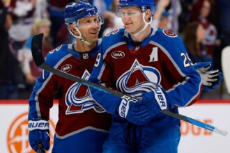 MacKinnon scores two goals and gets into rare fight in Avalanche's 8-4 season opening win over Kings