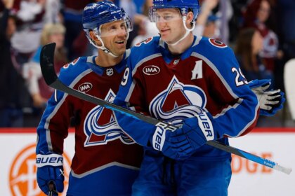 MacKinnon scores two goals and gets into rare fight in Avalanche's 8-4 season opening win over Kings